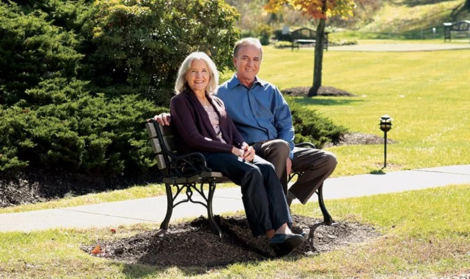 St. Barnabas couple sitting on bench
