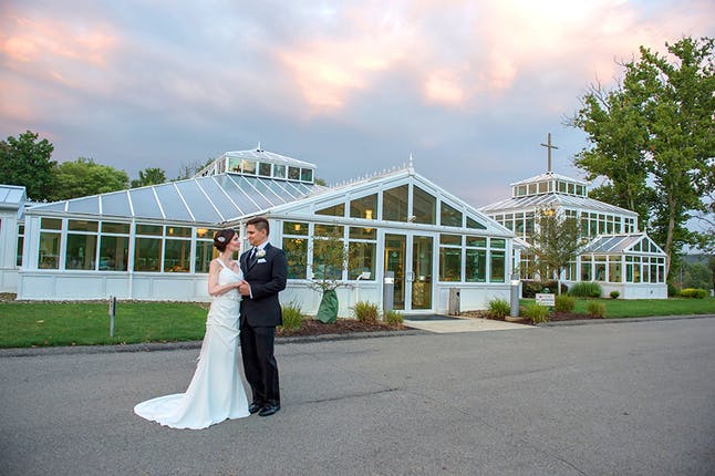 Newlyweds pose outside Crystal Conservatories at St. Barnabas Health System