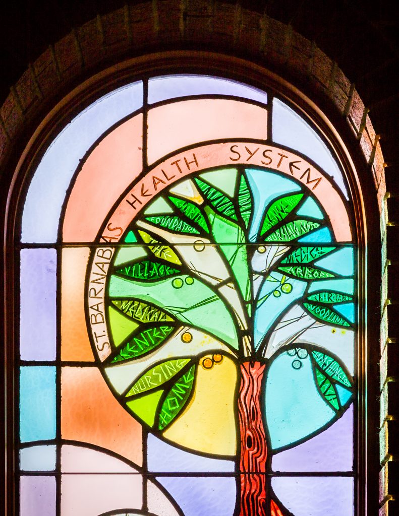 A stained-glass window at St. Barnabas Health System