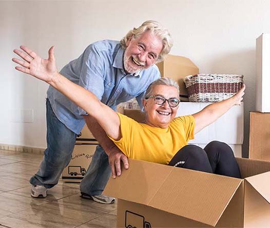 A happy couple unpacking boxes at White Tail Ridge